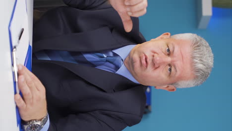 Vertical-video-of-Businessman-looking-at-camera-with-negative-gesture.